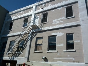 2nd & Wenatchee Ave, Exterior: Remove all failing paint, repair damaged concrete, prime all exposed concrete, prime and paint building in three colors.